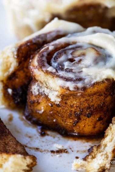 Close photo of a cinnamon roll showing the inside of the roll.