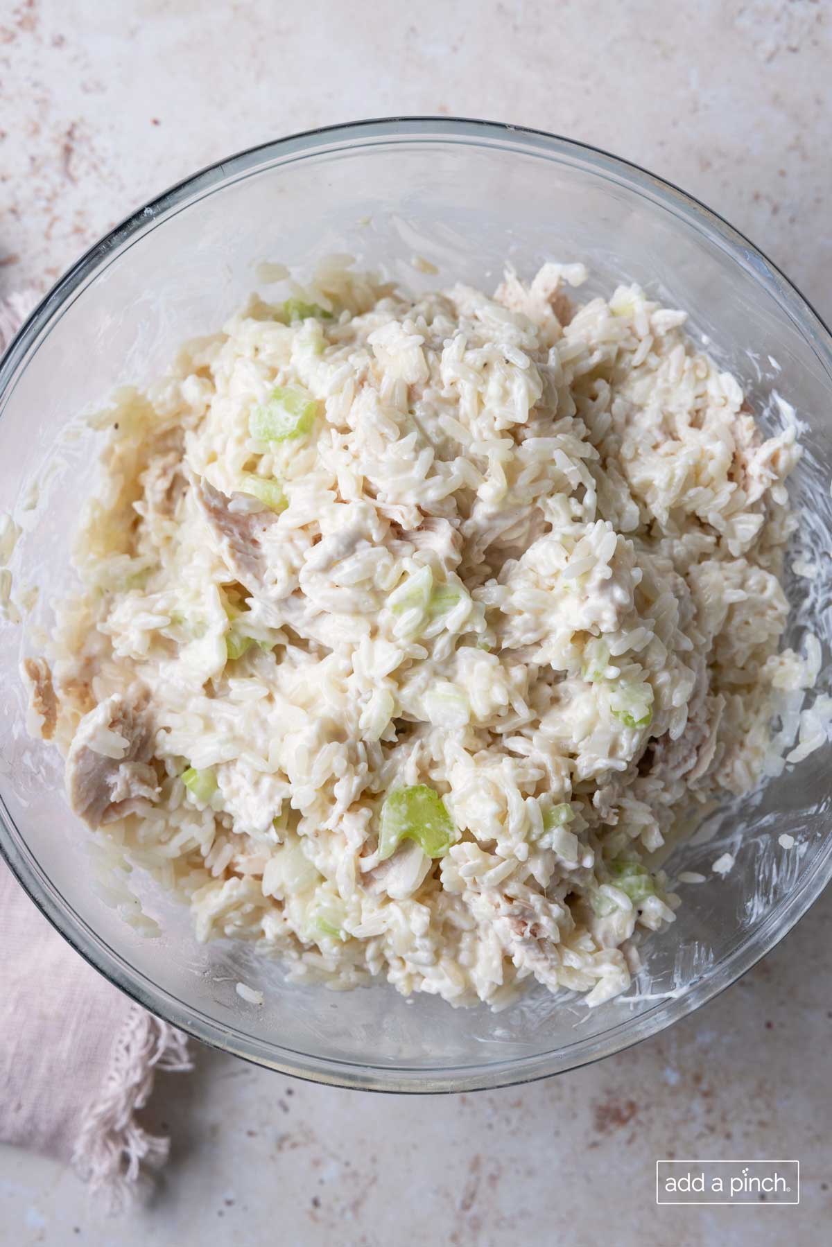 Chicken and rice casserole mixture in a glass bowl.