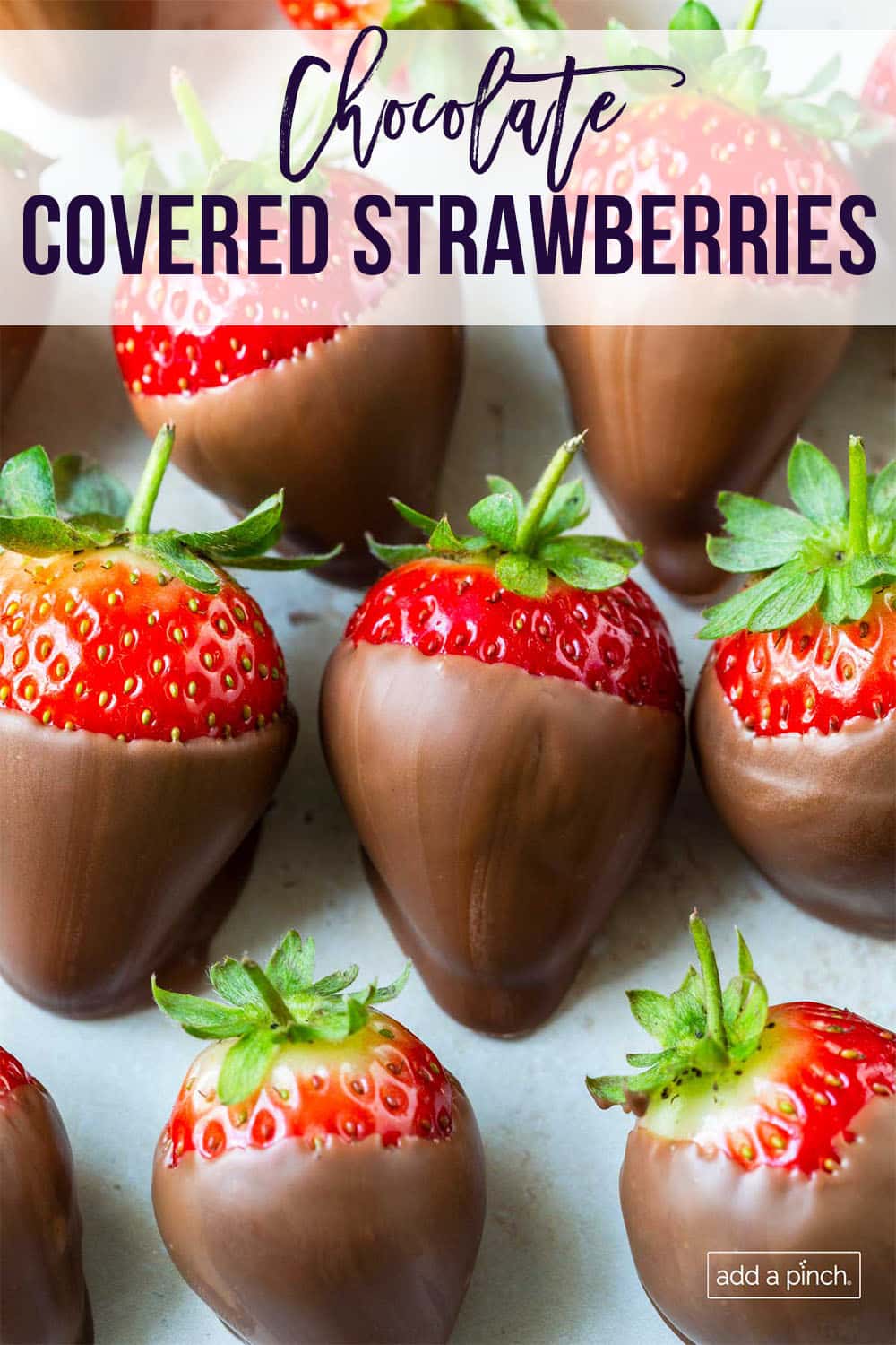 Rows of bright strawberries covered in chocolate - with text - addapinch.com