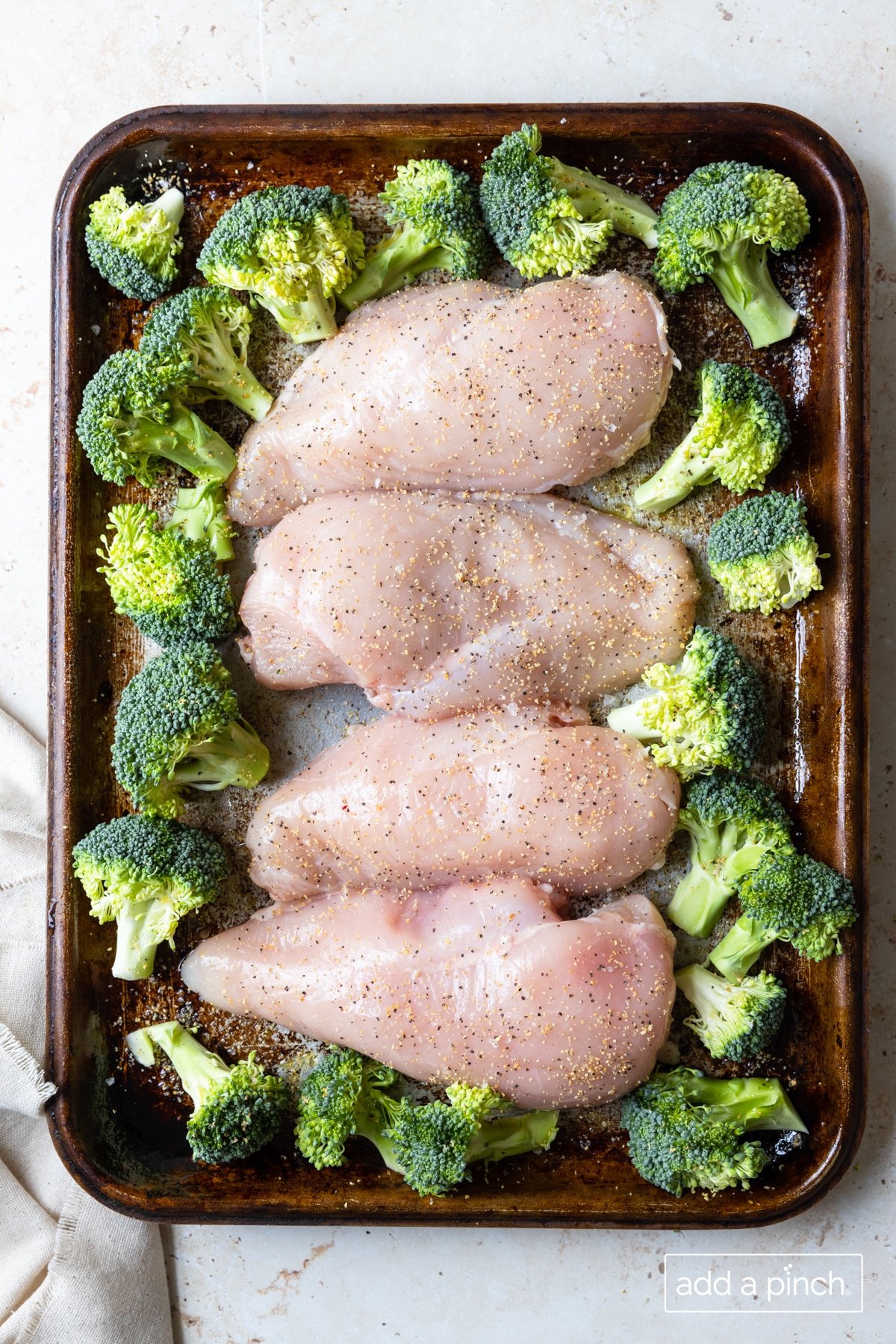 Photo of chicken and broccoli on a sheet pan