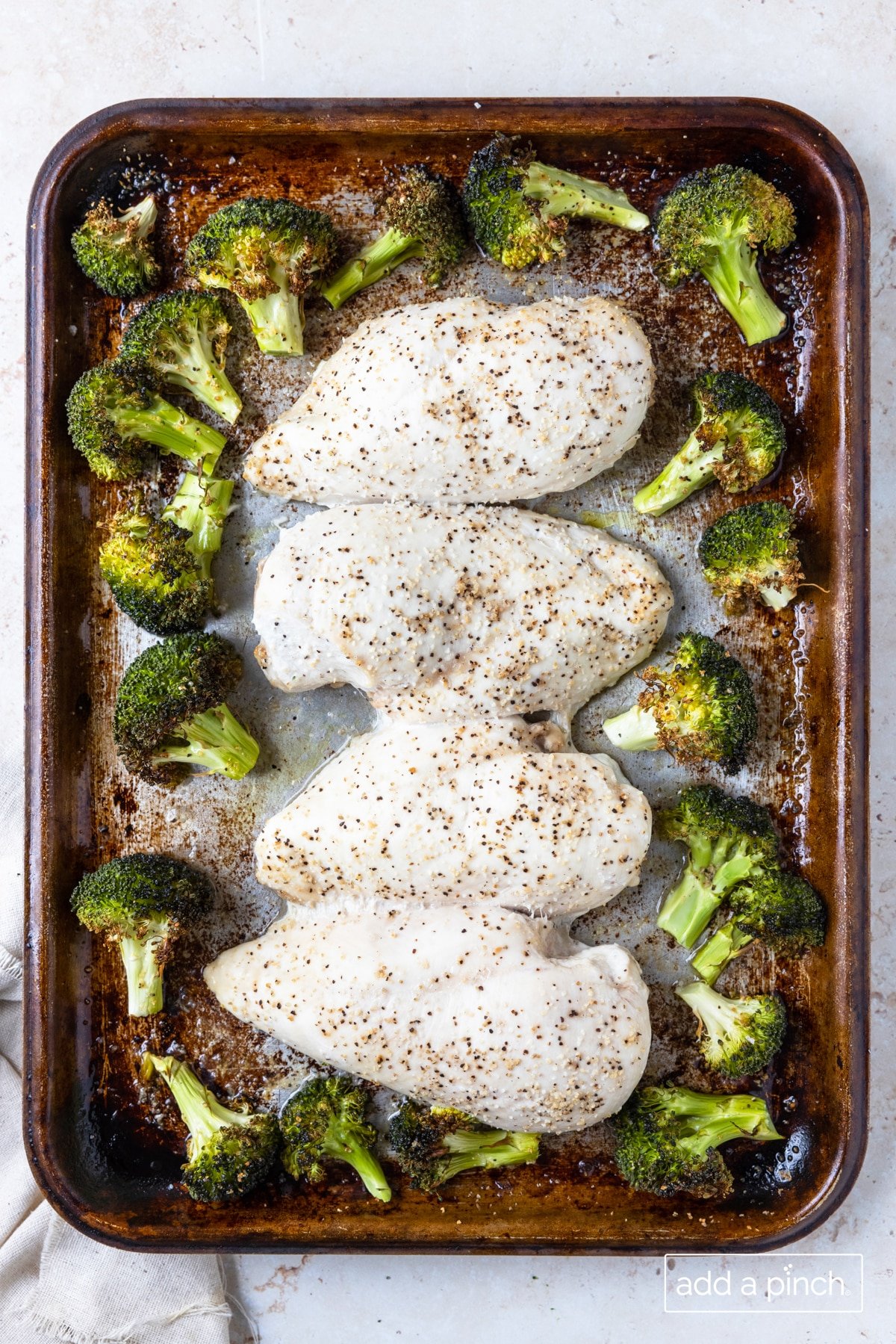 Baked chicken and broccoli ready for the parmesan crust.
