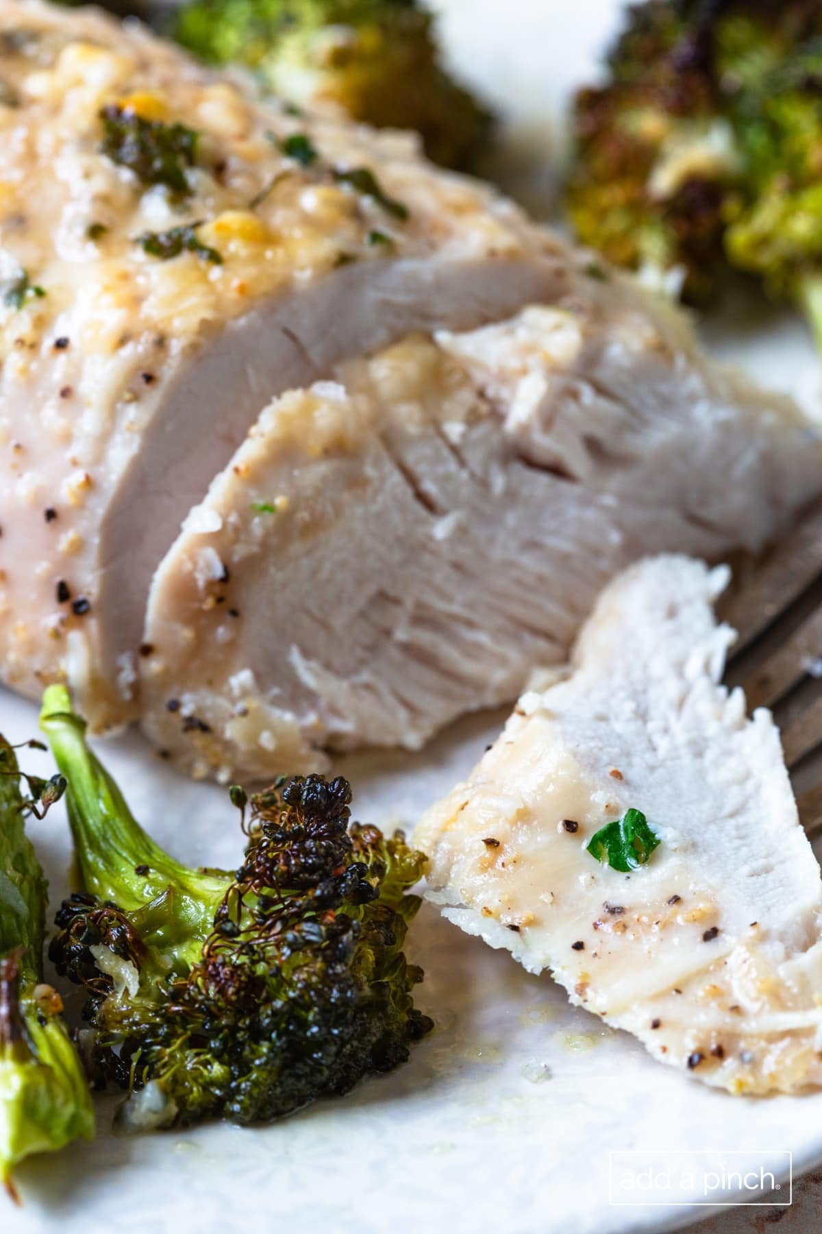 Photo of parmesan crusted chicken dinner with broccoli.