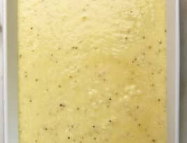 Photo of grits casserole mixture added to a baking dish for cooking.