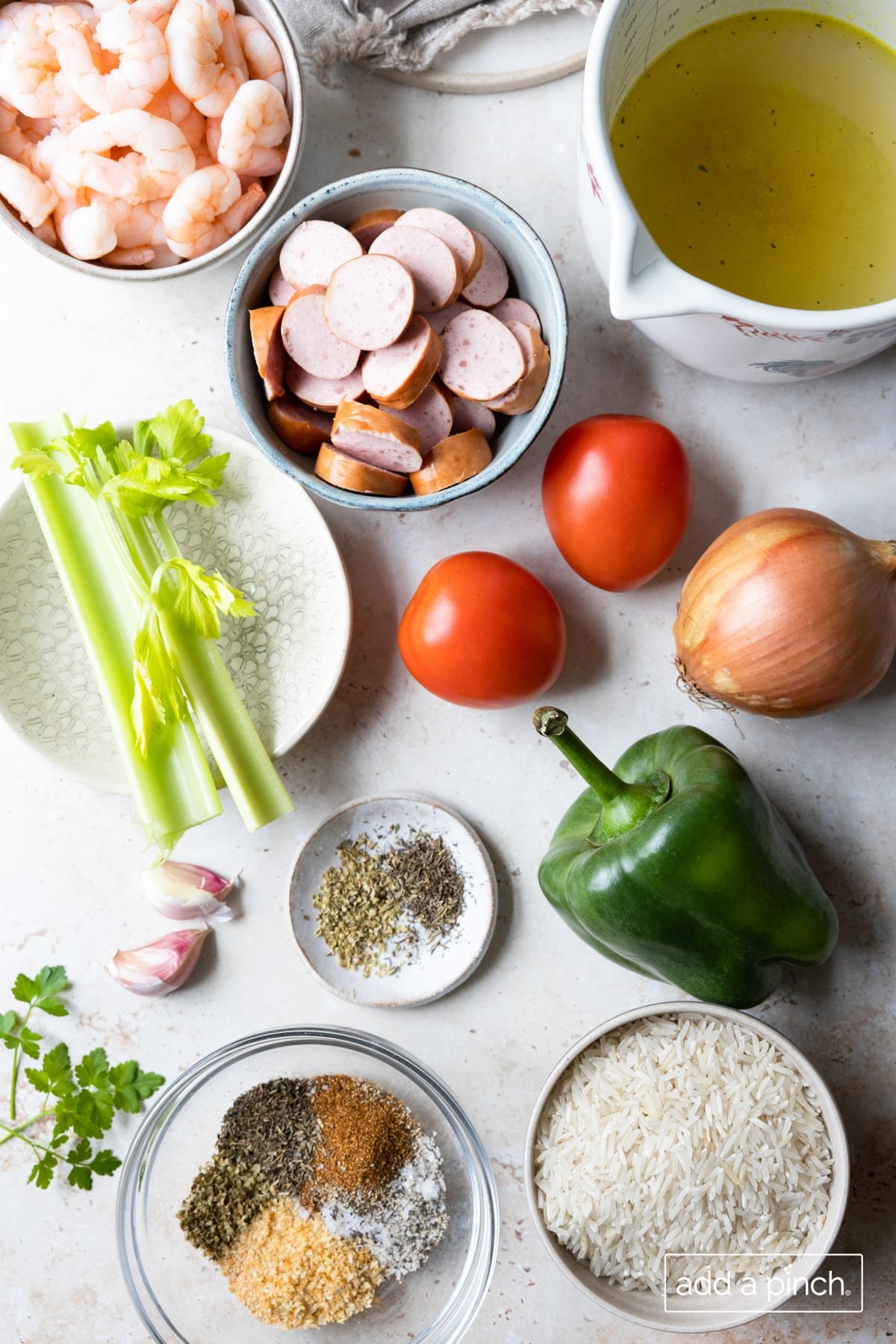 Photo of ingredients for easy jambalaya recipe on a white background.
