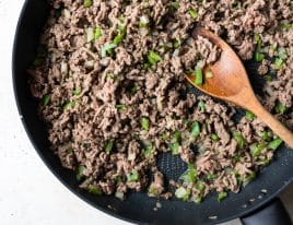 Photo of cooked ground beef, onion, and green pepper in a skillet.