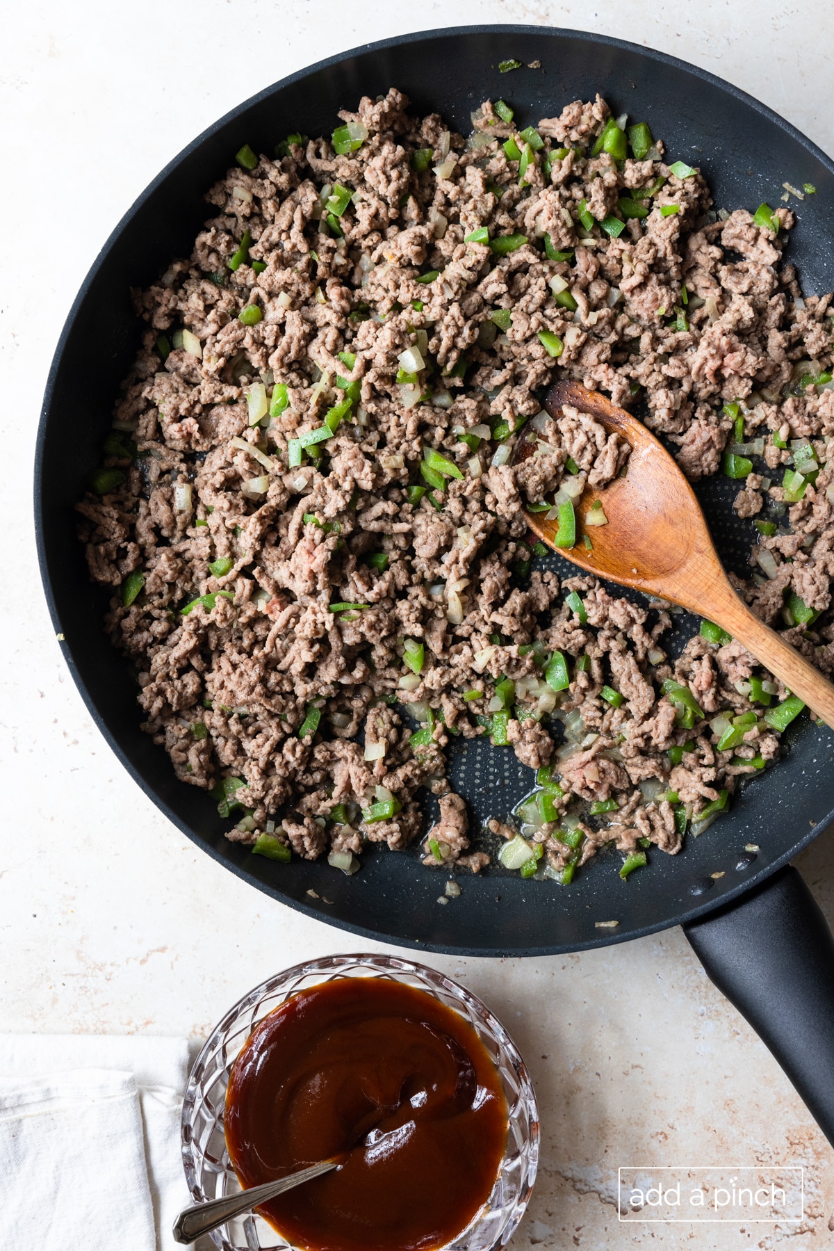 Photo of cooked ground beef, onion, and green pepper in a skillet.
