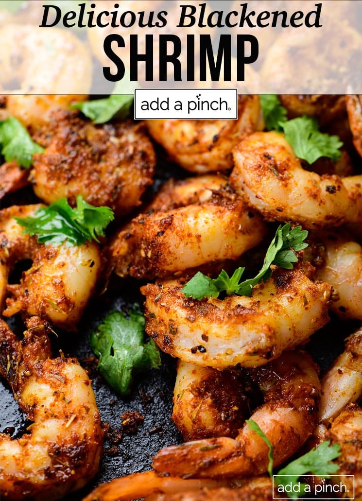 Blackened shrimp in a skillet with fresh herbs - with text - addapinch.com