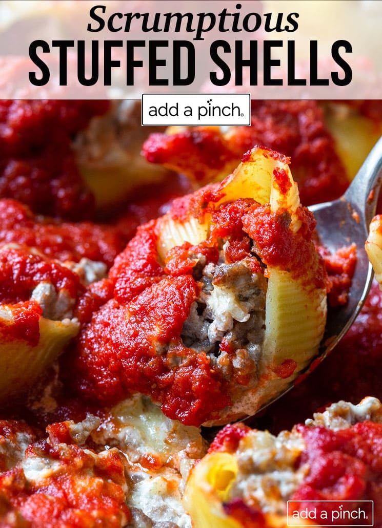 Closeup of cheese and meat-stuffed pasta shells being lifted by a stainless spoon - with text - addapinch.com