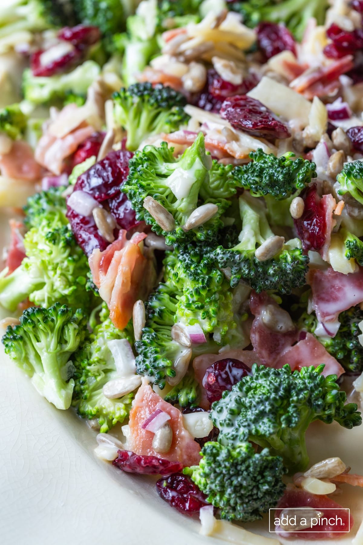 Photo of broccoli salad on a white platter.