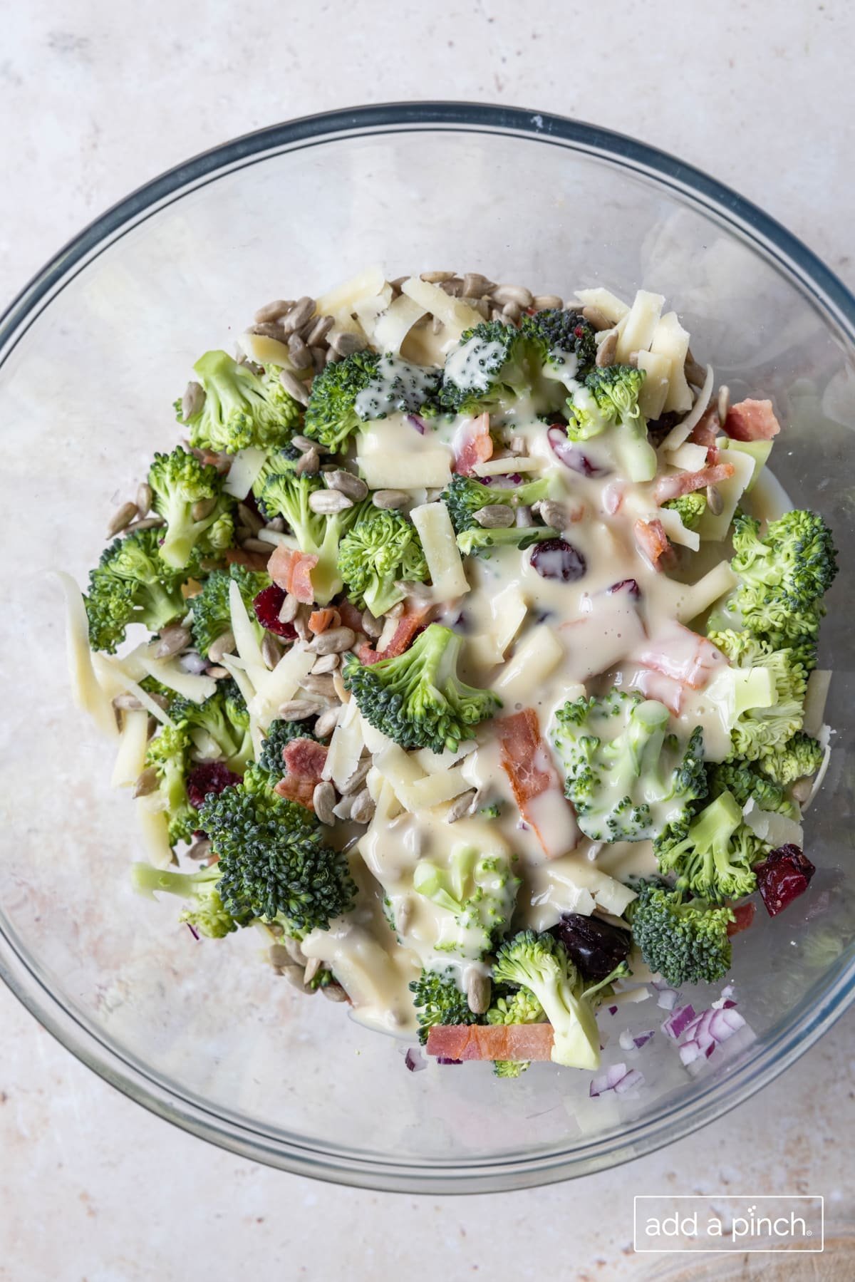 Photo of broccoli salad with homemade dressing added on top.