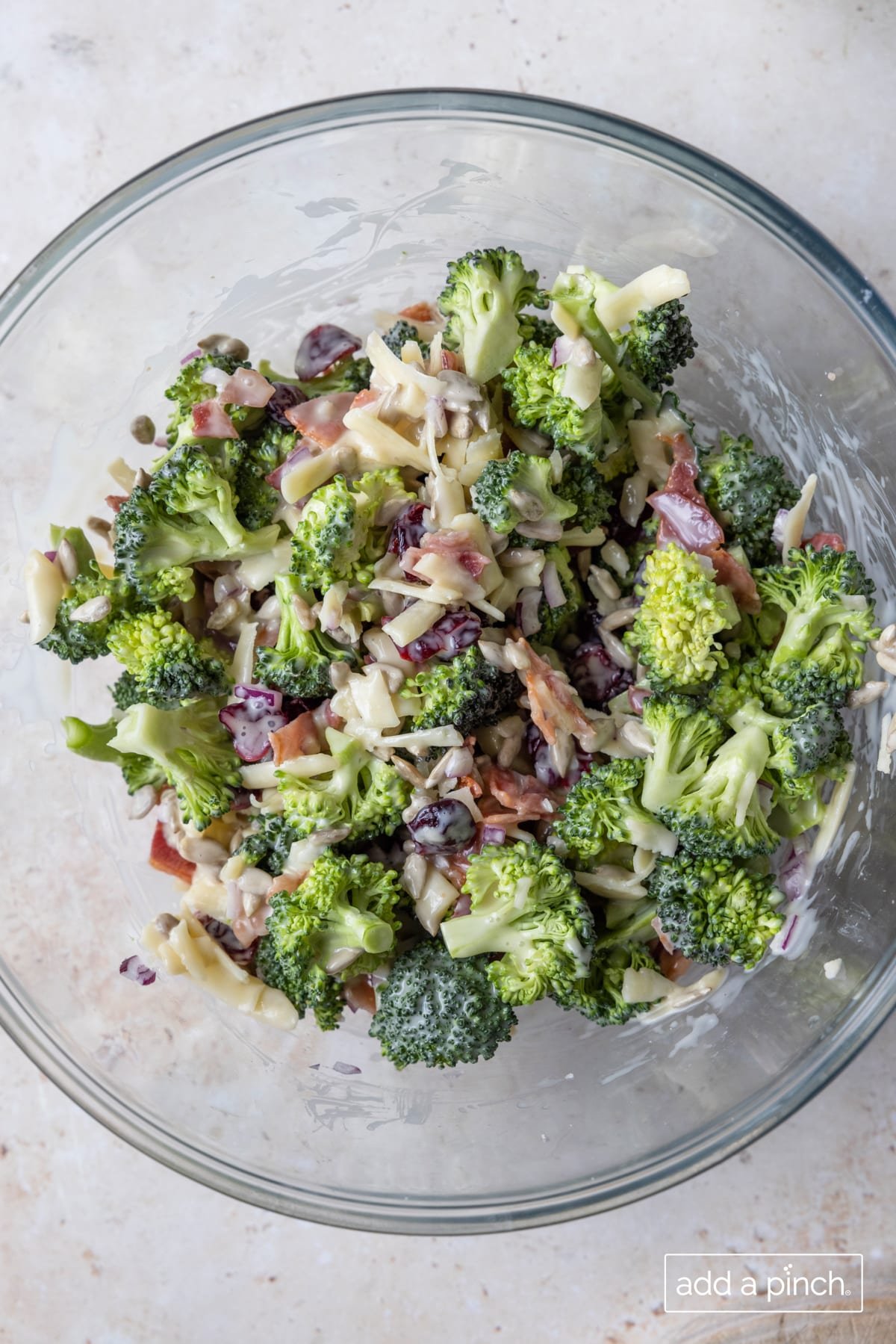 Photo of broccoli salad recipe in a glass bowl.