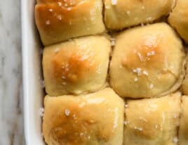 Baked dinner rolls brushed with butter and sprinkled with salt.