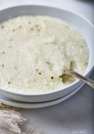 Bowl of southern-style grits in a white bowl.