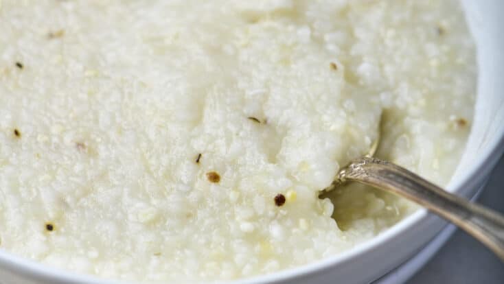 Bowl of southern-style grits in a white bowl.