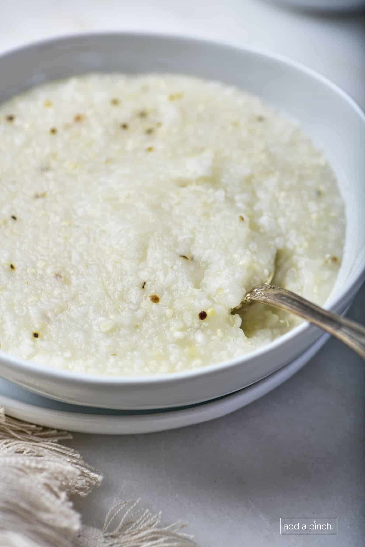 Bowl of southern-style grits in a white bowl.
