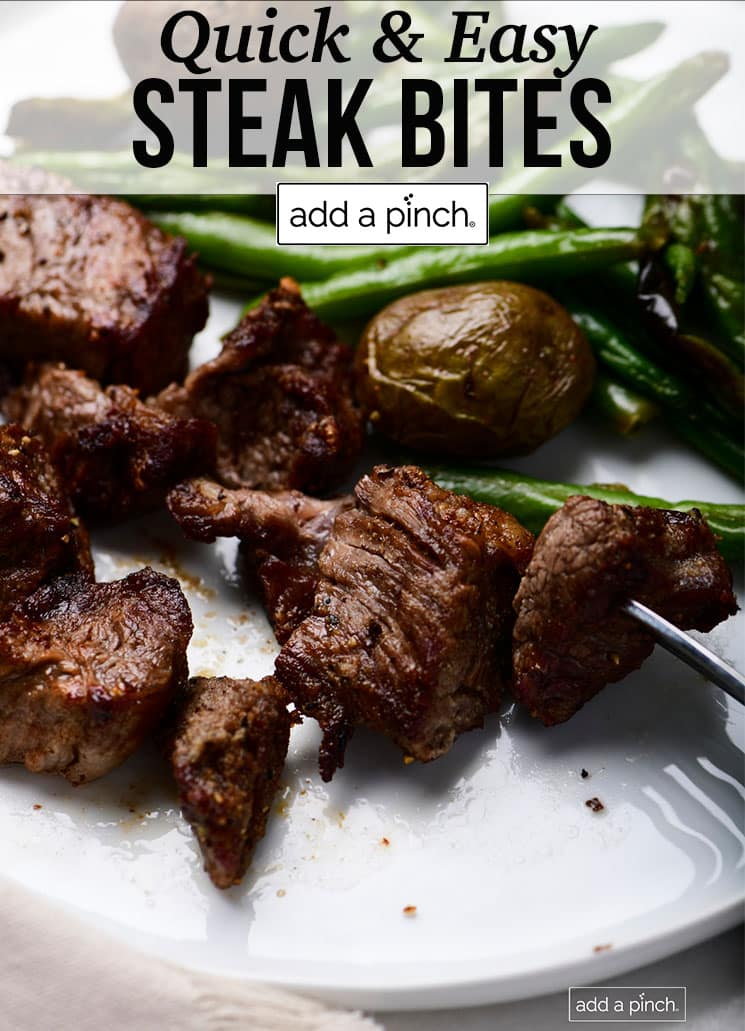 Plate with steak bites, green beans and potatoes - with text - addapinch.com
