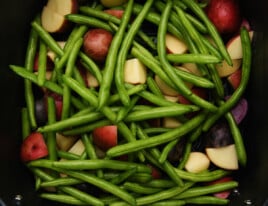 Green beans and potatoes in air fryer basket