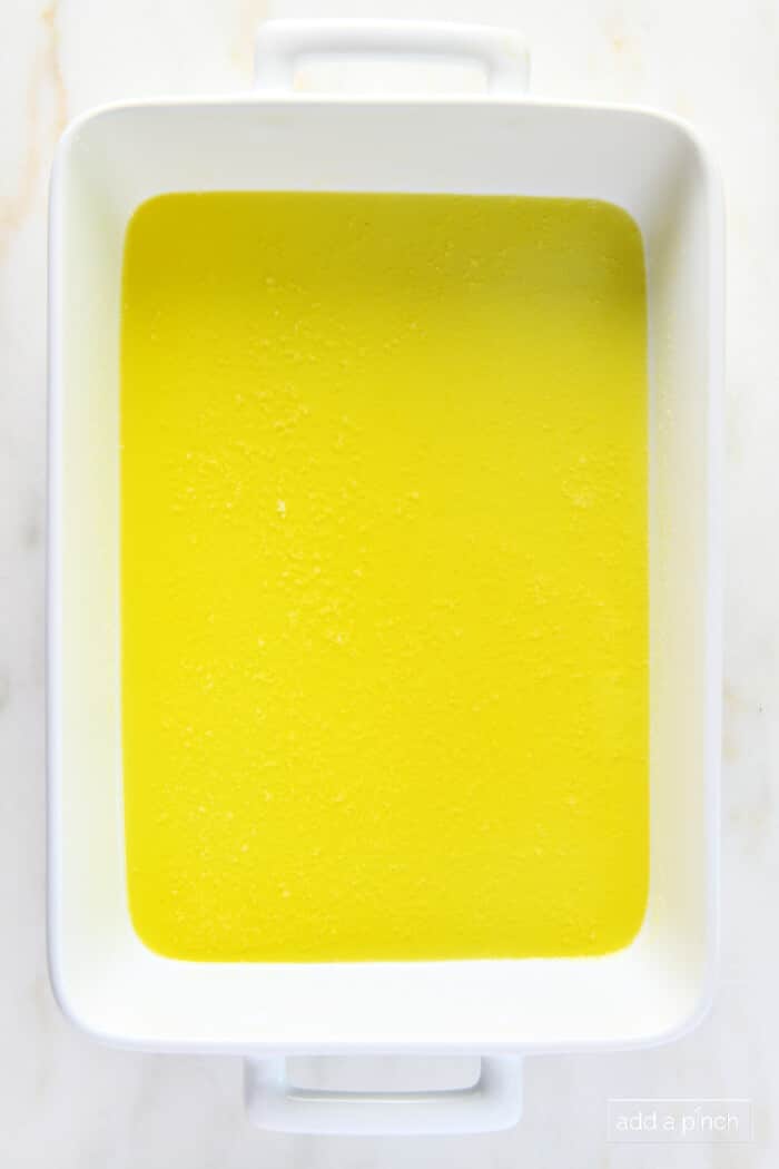 Melted butter in a white baking dish