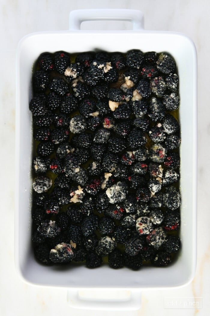 Sugared blackberries in a white baking dish.