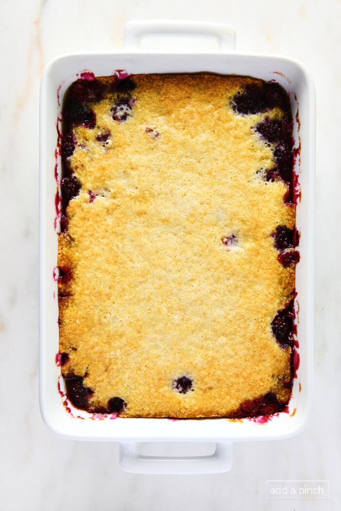 Baked cobbler in a white baking dish.