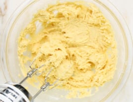 Final sugar cookie dough mixture in a glass mixing bowl