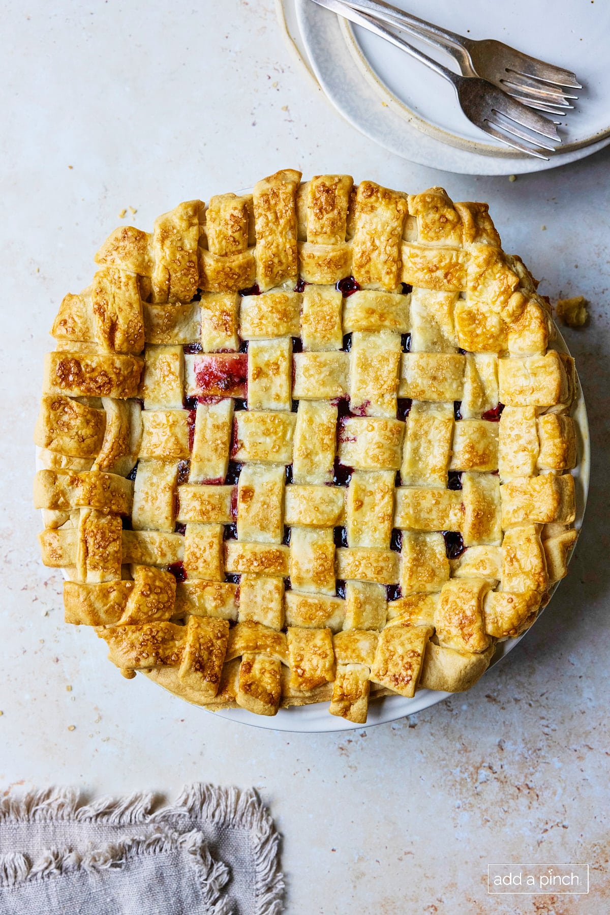 Baked cherry pie with lattice pie crust topping.