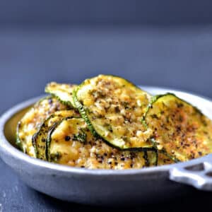 Zucchini Chips sprinkled with Parmesan and spices in a pewter bowl - addapinch.com