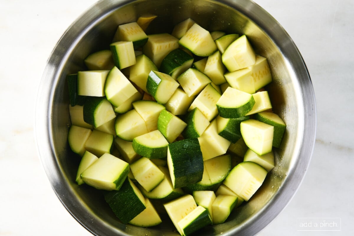 Cut zucchini pieces in a mixing bowl.