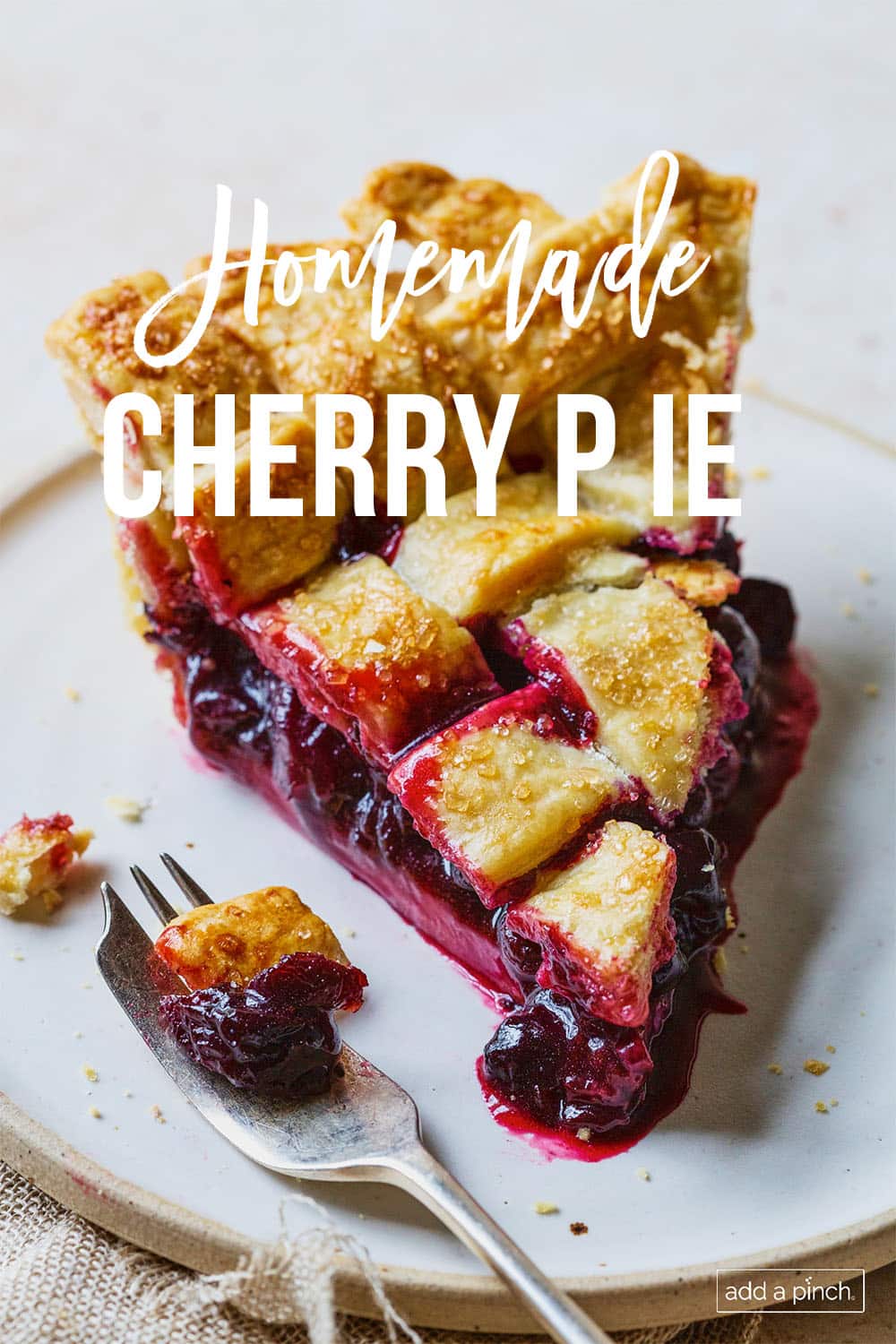 Slice of lattice topped cherry pie and a fork - with text - addapinch.com
