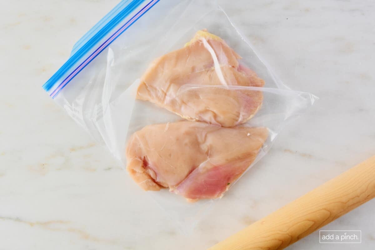 Chicken breasts in a sealed bag to be pounded for cooking.