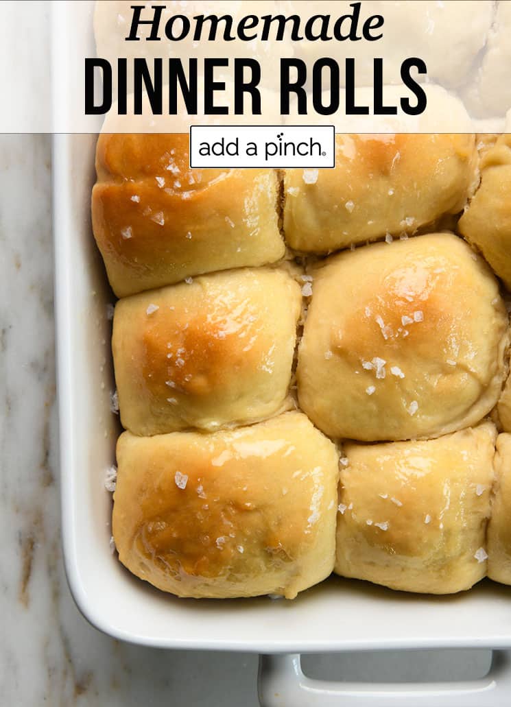 Baking dish with buttery homemade dinner rolls - with text - addapinch.com