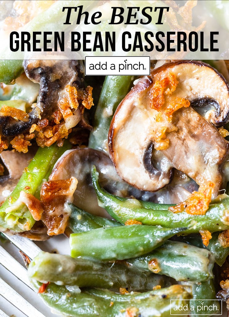 Green bean casserole with creamy sauce and mushroom slices - with text - addapinch.com
