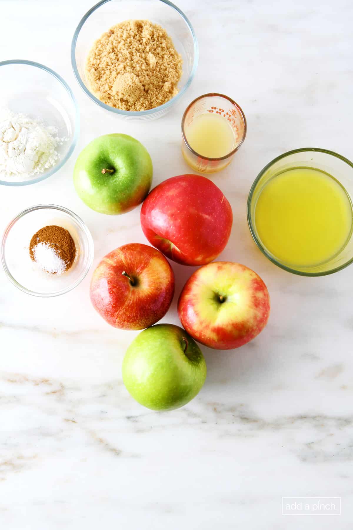 Ingredients used to make apple cobbler filling on a marble countertop.