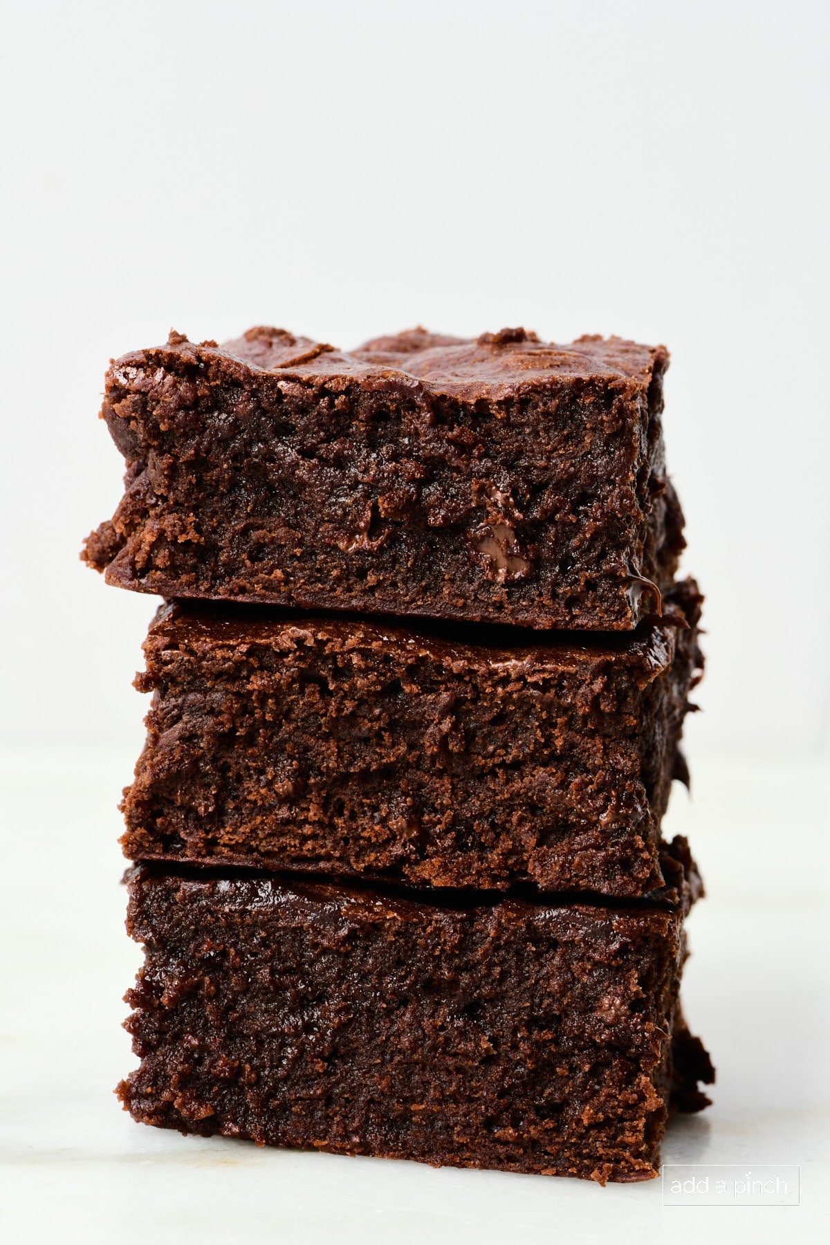 Stack of the best brownies on a marble countertop.