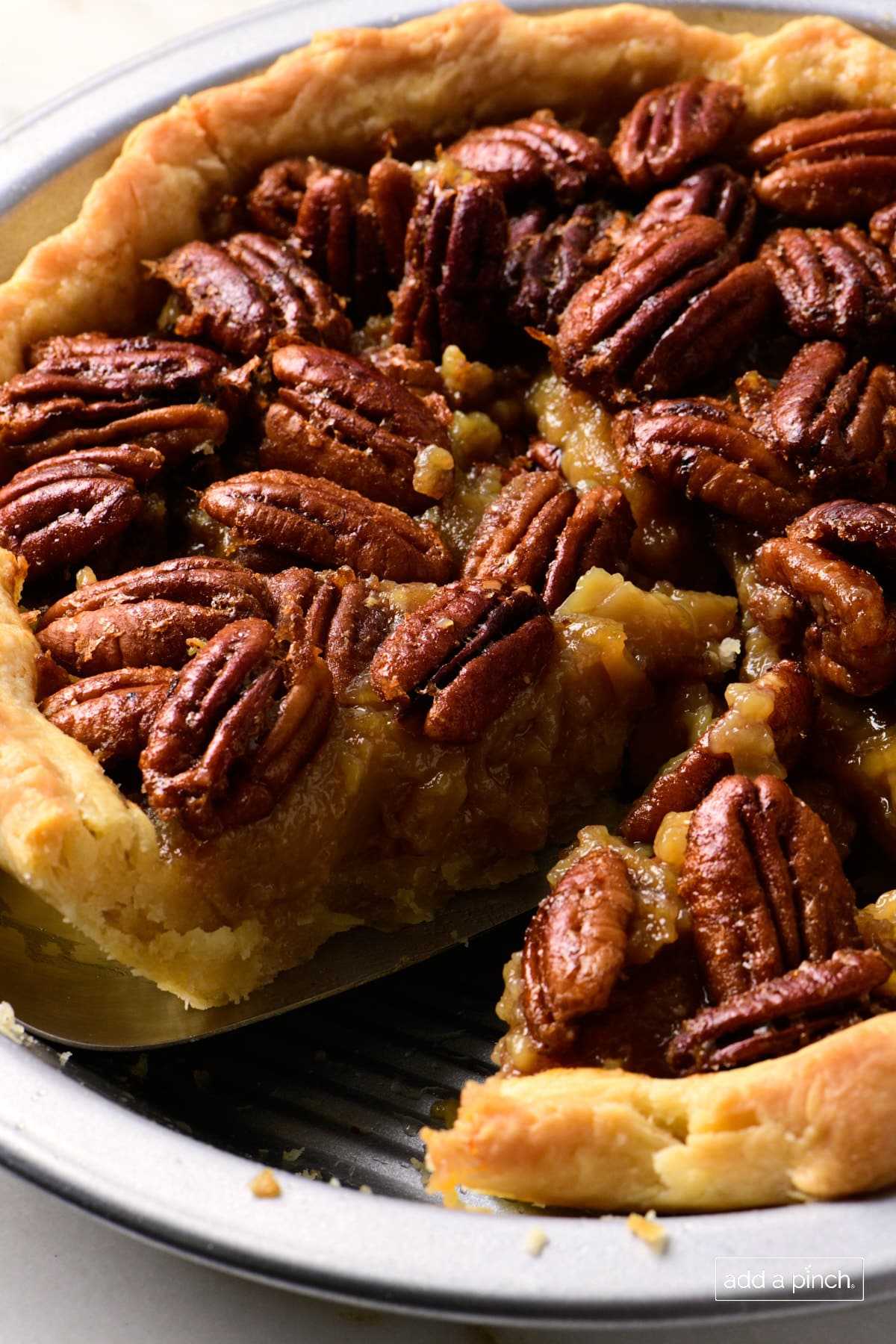 Pecan pie that has one slice removed.