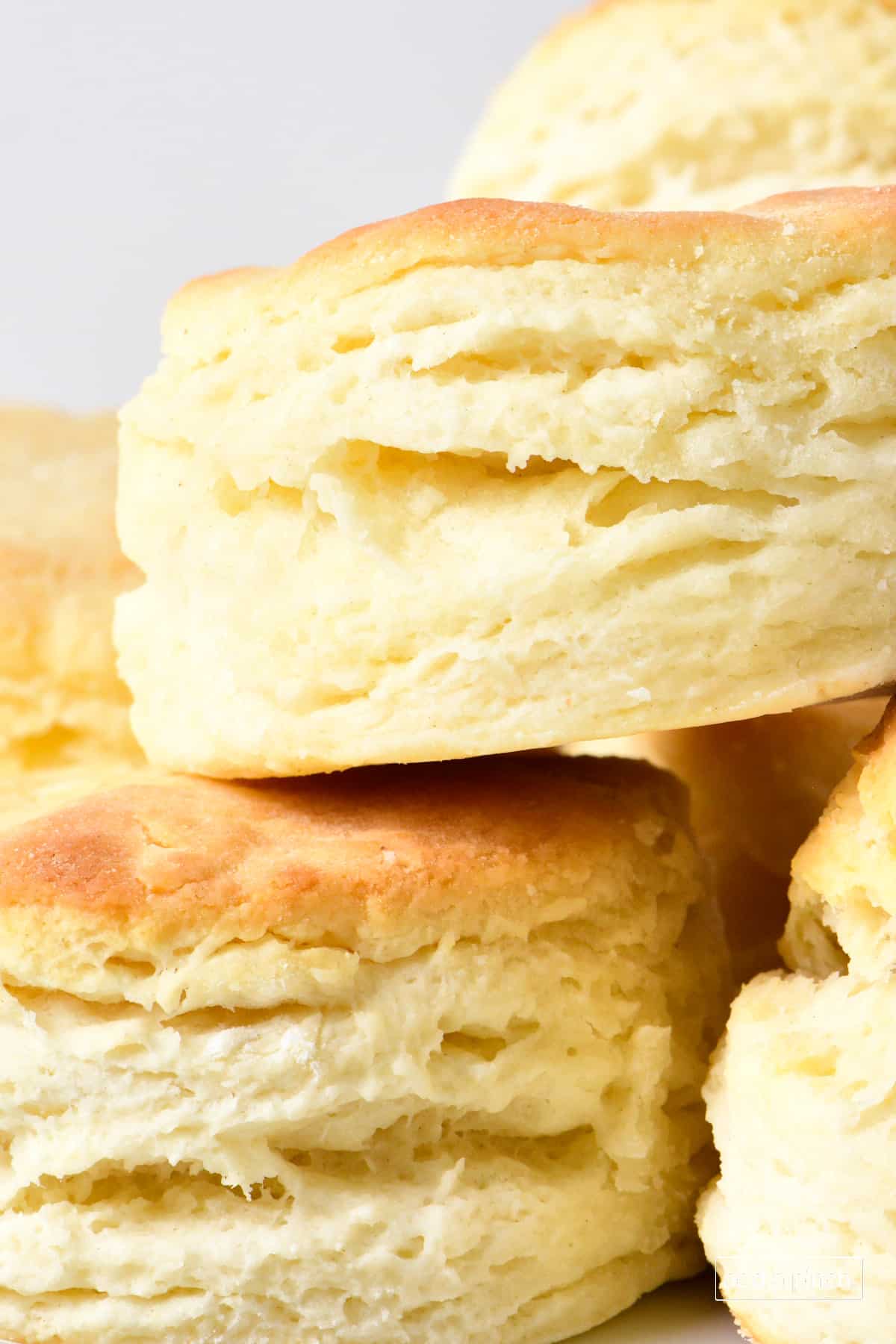 Closeup of flaky layers on a stack of golden biscuits.