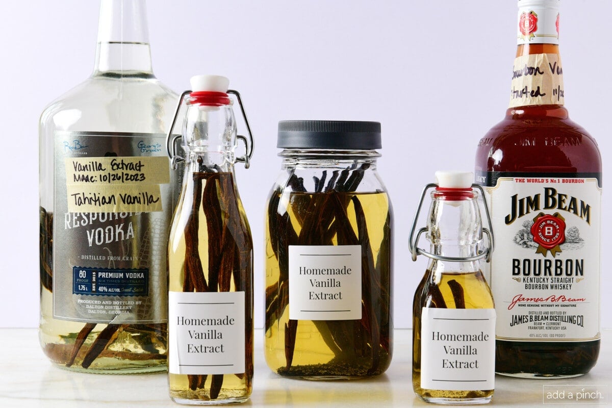 Line up of various sizes and styles of bottles used to store vanilla extract.