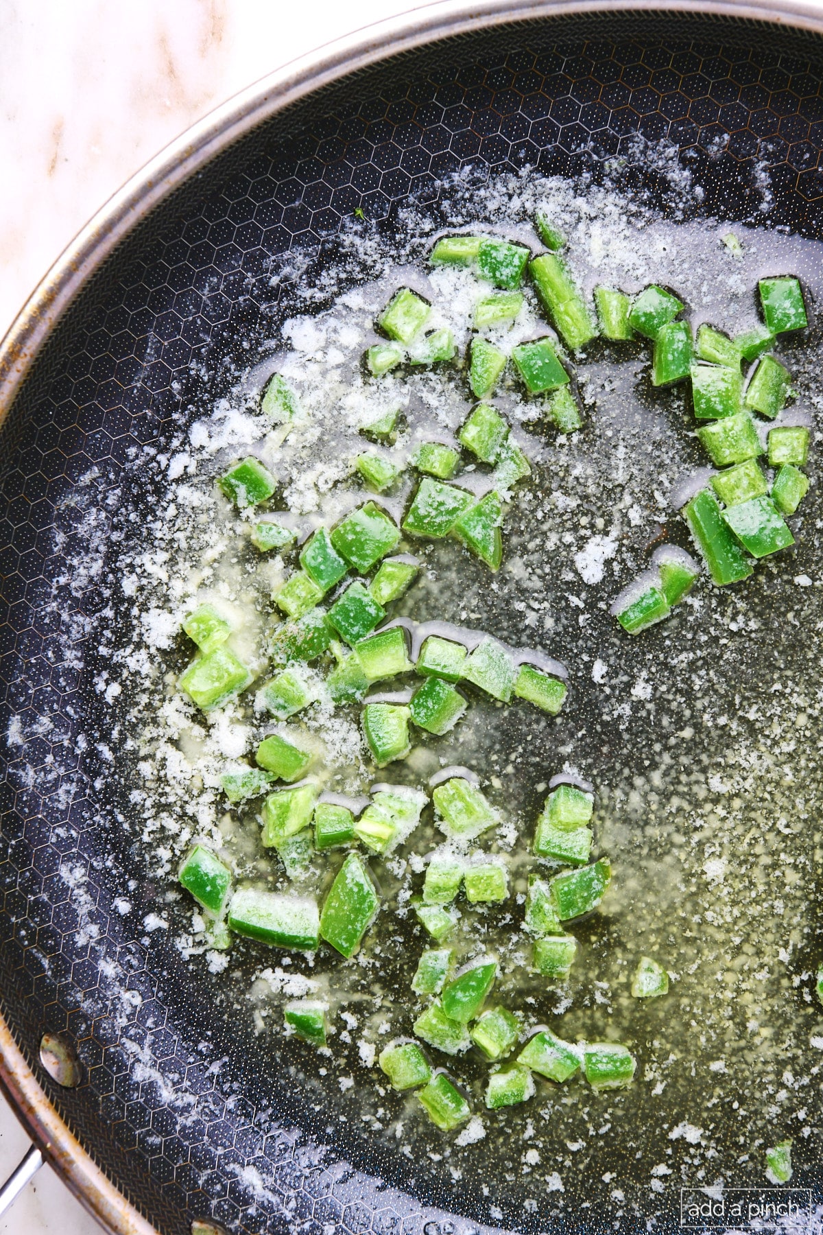 Jalapeno sauteed in butter in a skillet.