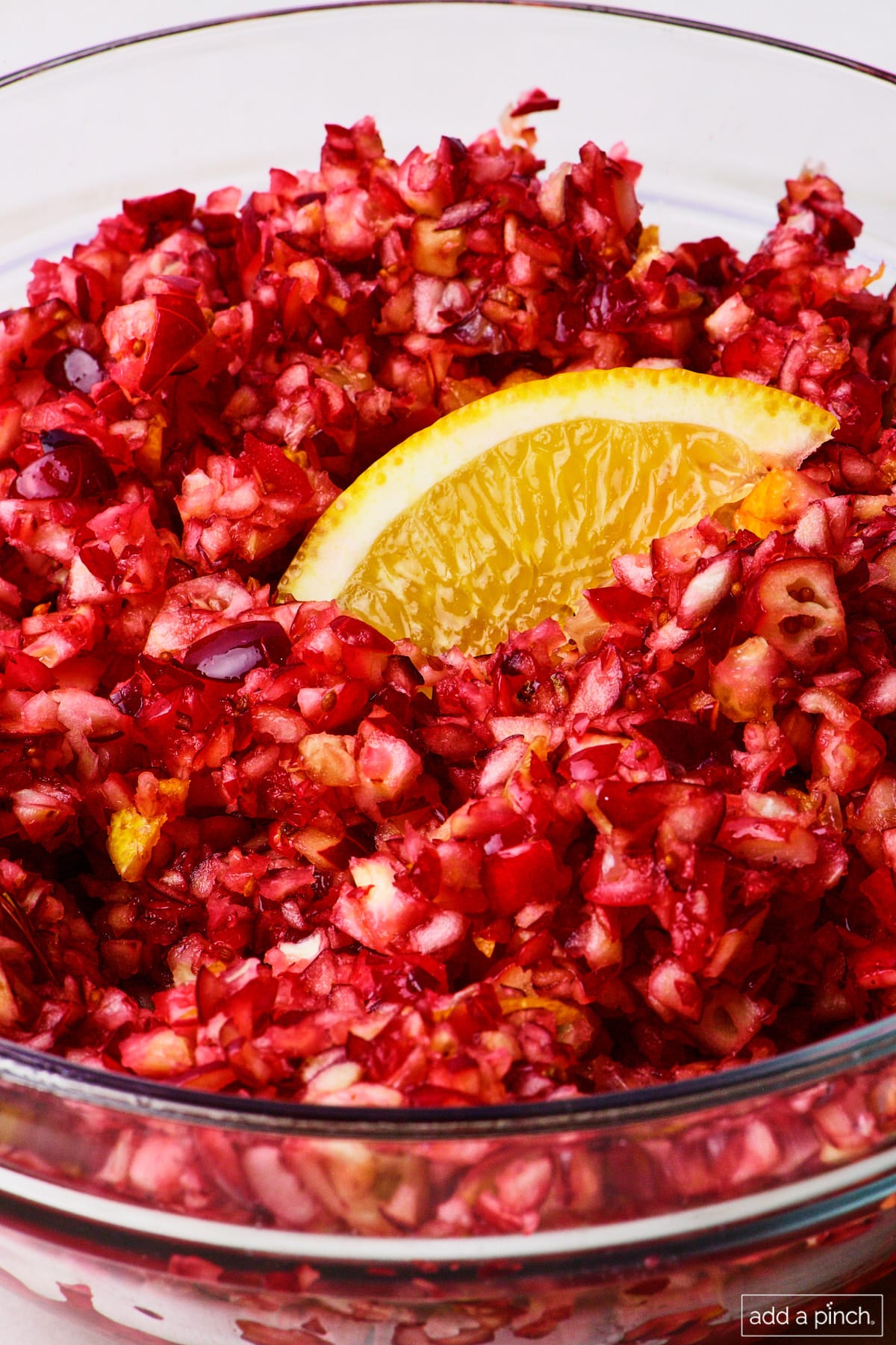 Fresh cranberry relish topped with an orange slice.