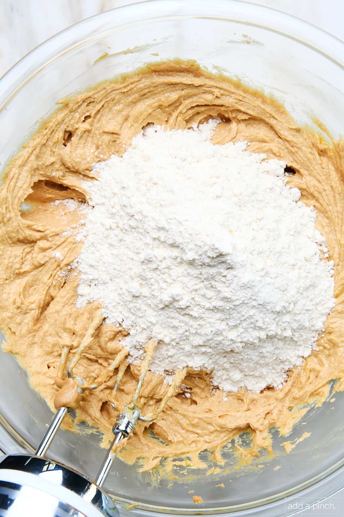 Peanut butter mixture with flour in mixing bowl.