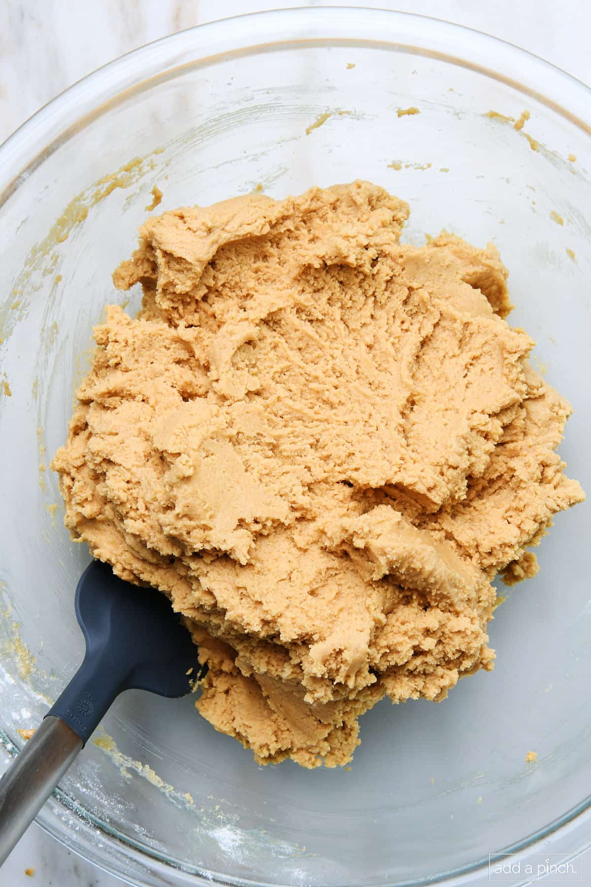 Peanut butter cookie dough in a mixing bowl.