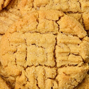 Closeup of baked peanut butter cookie with criss cross pattern on top.