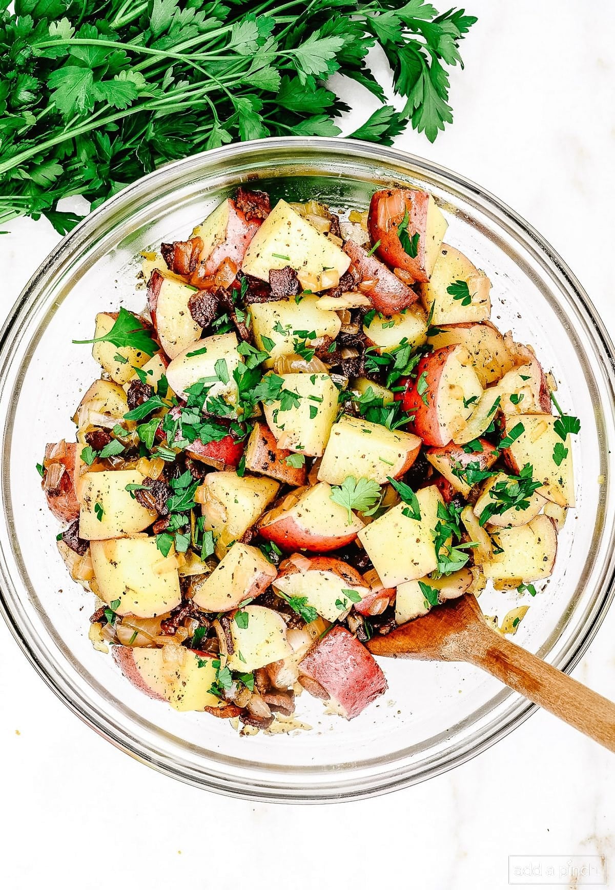 Glass bowl with warm bacon potato salad
