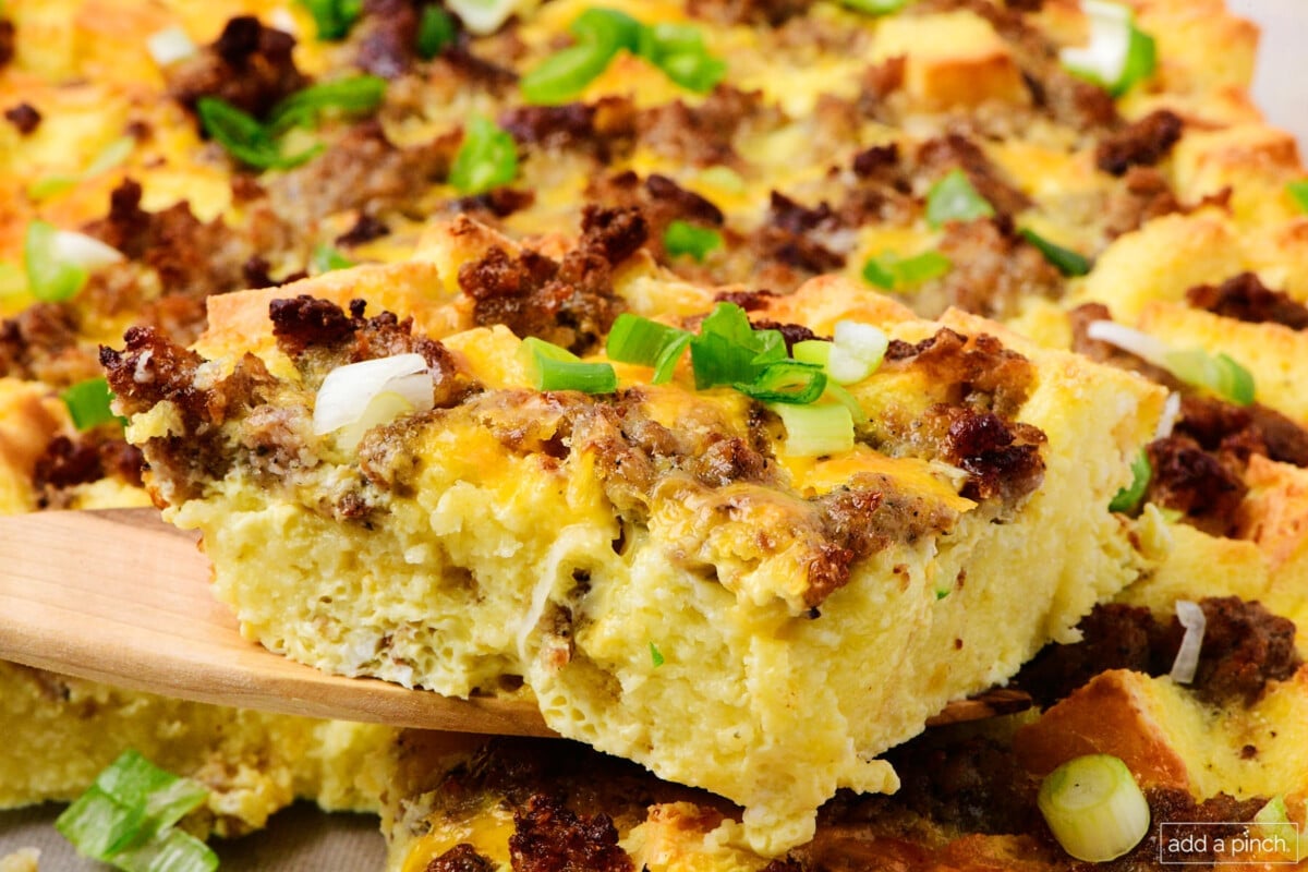 Photo of breakfast casserole with sprinkles of green onion with egg and sausage.