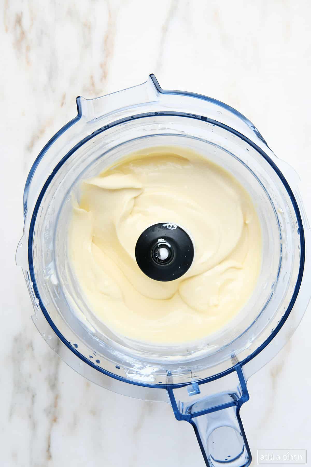 Cheesecake pie mixture in a food processor bowl.