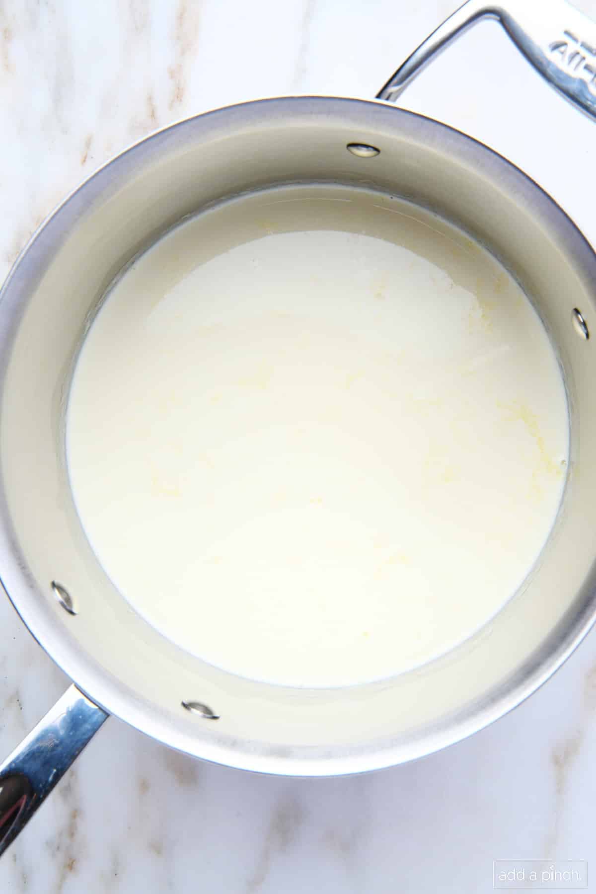 Milk and cream in a heavy bottomed saucepan. 