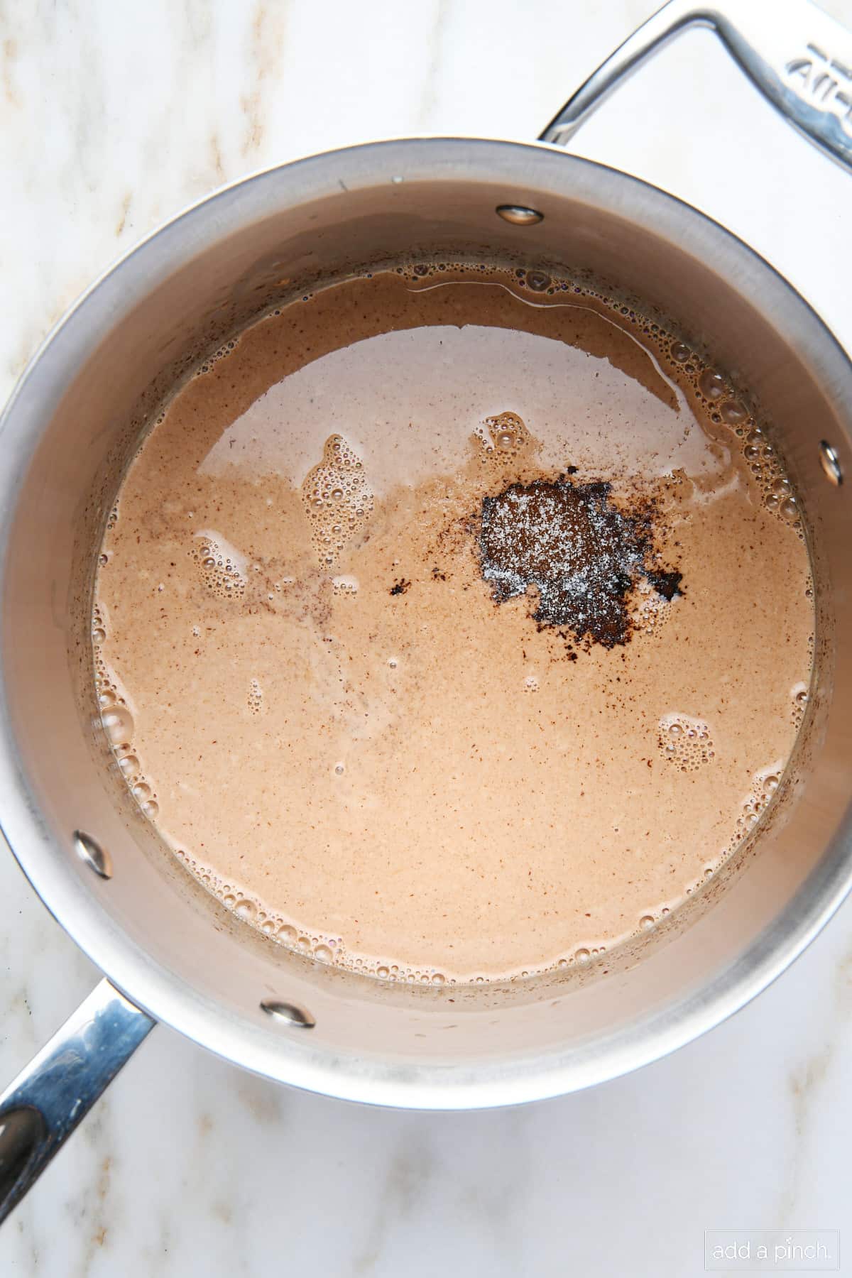 Espresso powder, vanilla, and salt added to chocolate and cream. 
