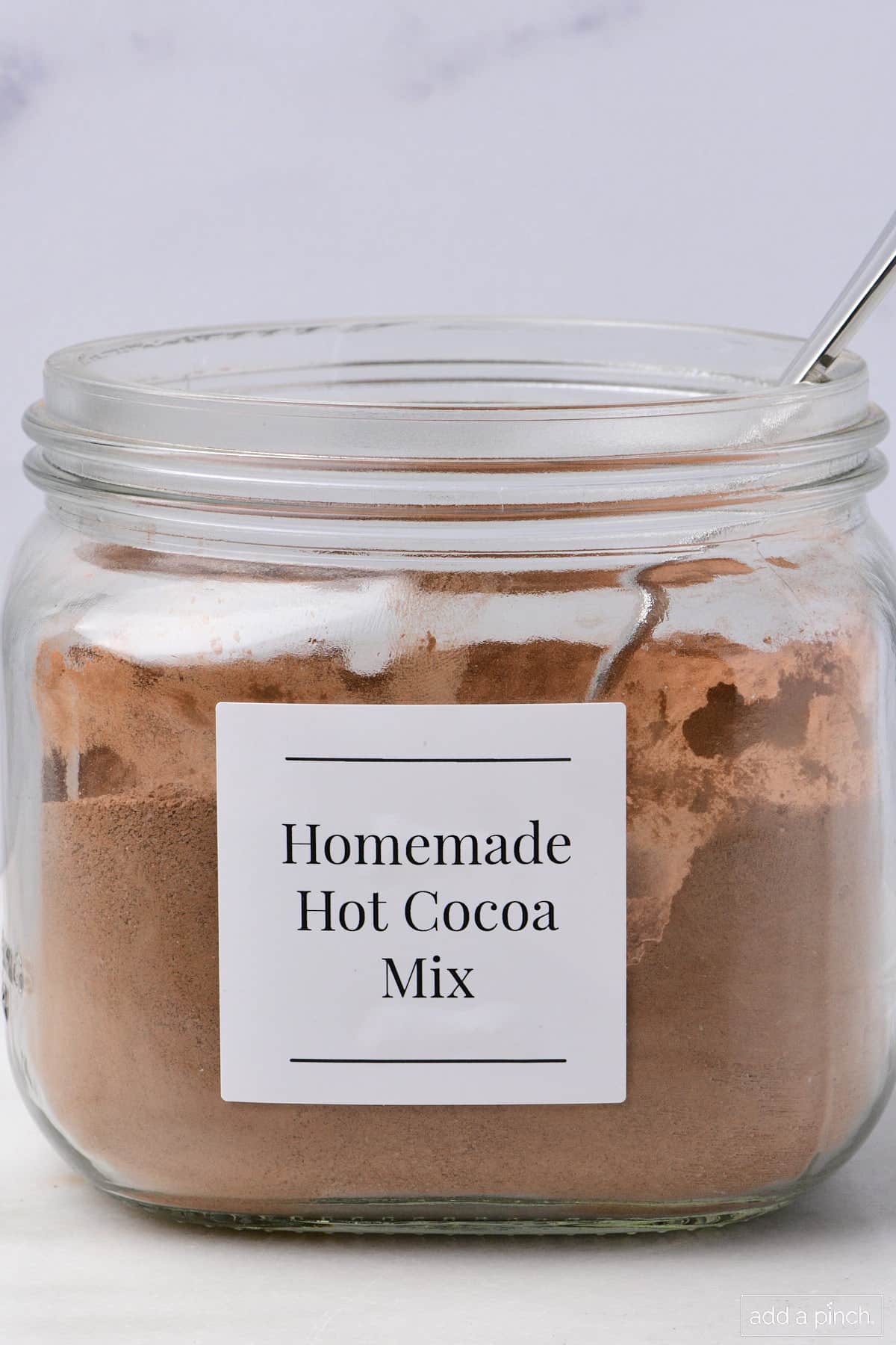 Homemade hot cocoa mix in a glass jar.