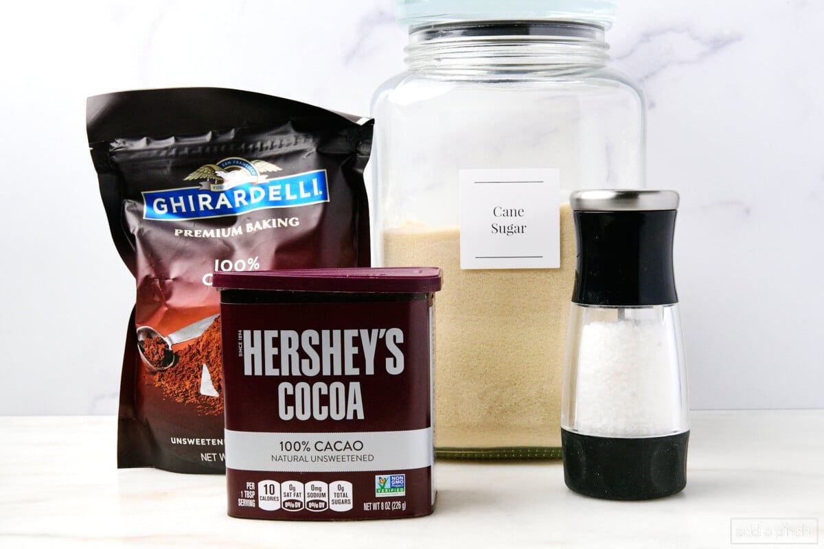 Ingredients to make hot cocoa with options for the unsweetened cocoa powder.