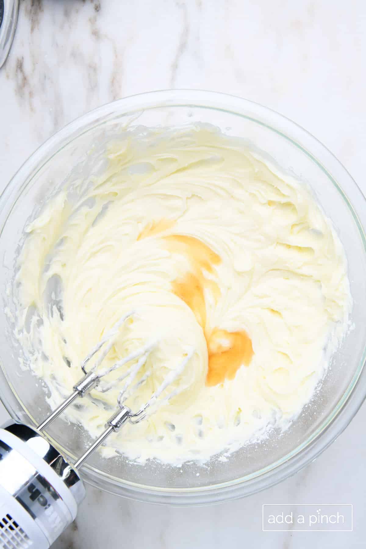 Vanilla extract added to cream cheese frosting mixture and mixed with hand mixer. 